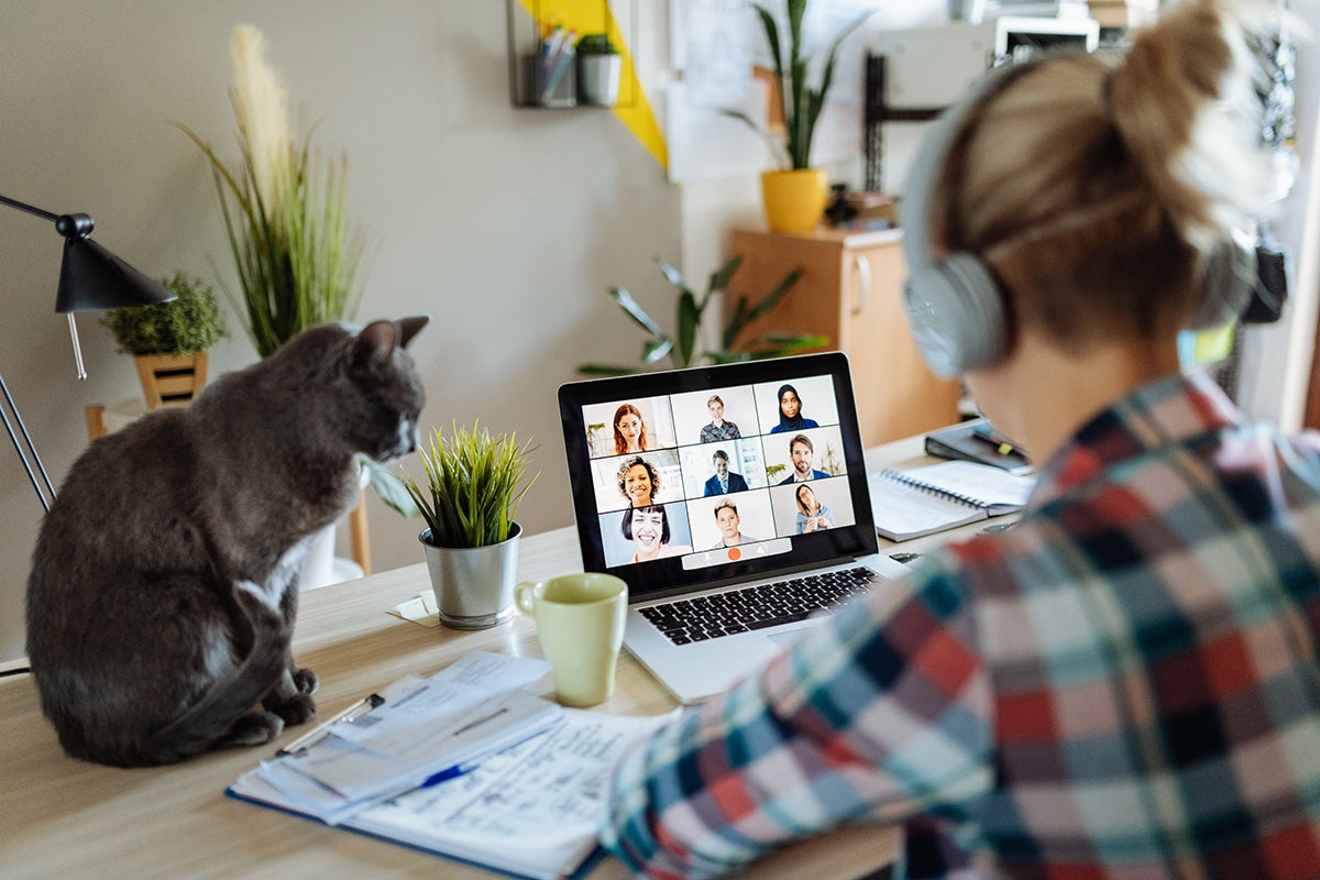 woman with headphones in online meeting