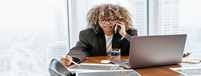 woman on computer and phone