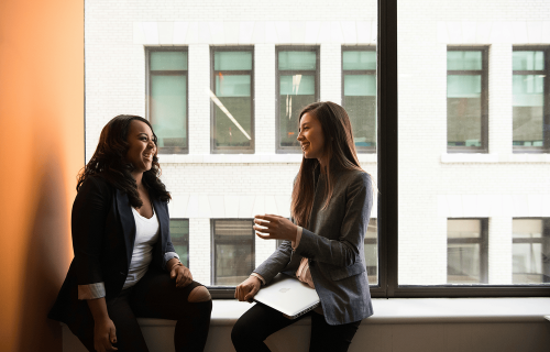 Two women sitting and talking.