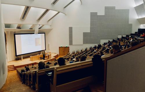 A person speaking to a crowd in a UCLA lecture hall.