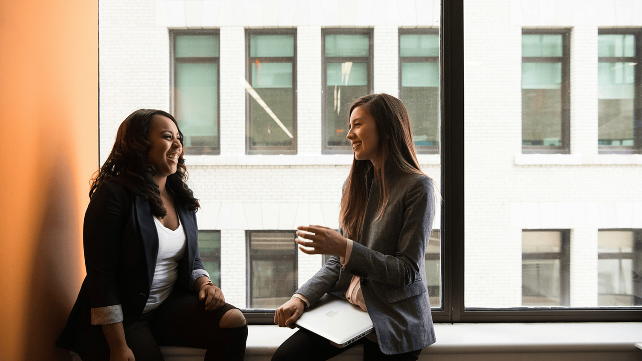 Two women sitting and talking.