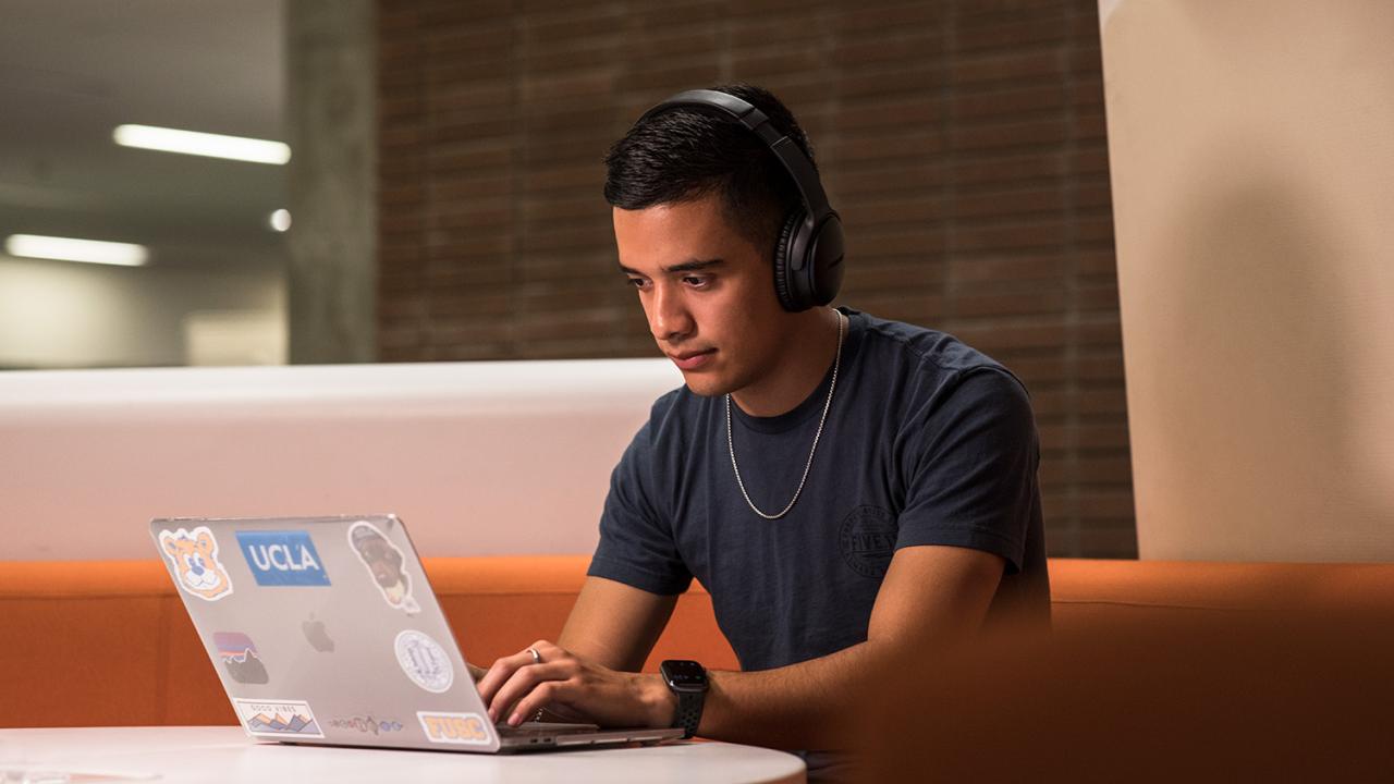 UCLA student studying with a laptop.