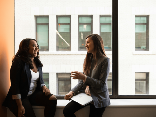Two women sitting and talking.